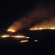 A Controlled fire burns a field in the middle of the night in rural Kansas.
